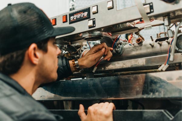 Cafe Design by Amavida Coffee Espresso Tech, working on a La Marzocco