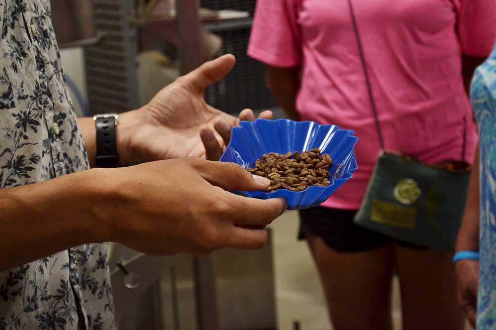 Director of Coffee, Martin Trejo, holding fresh roasted beans at the coffee roaster tour.