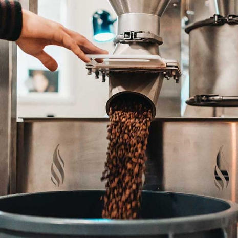 Freshly roasted Carbon Neutral coffee dropping out of a Loring SmartRoast at Amavida Coffee in Florida