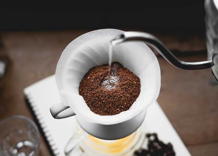 Pour over coffee being made at Amavida Coffee and Trading Company with Hario dripper and electric kettle.